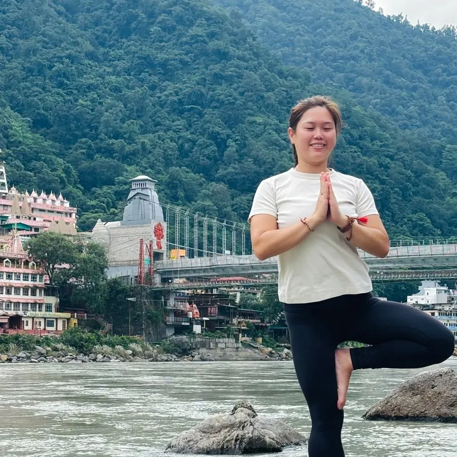 Tree pose on a river rock by the Ganga