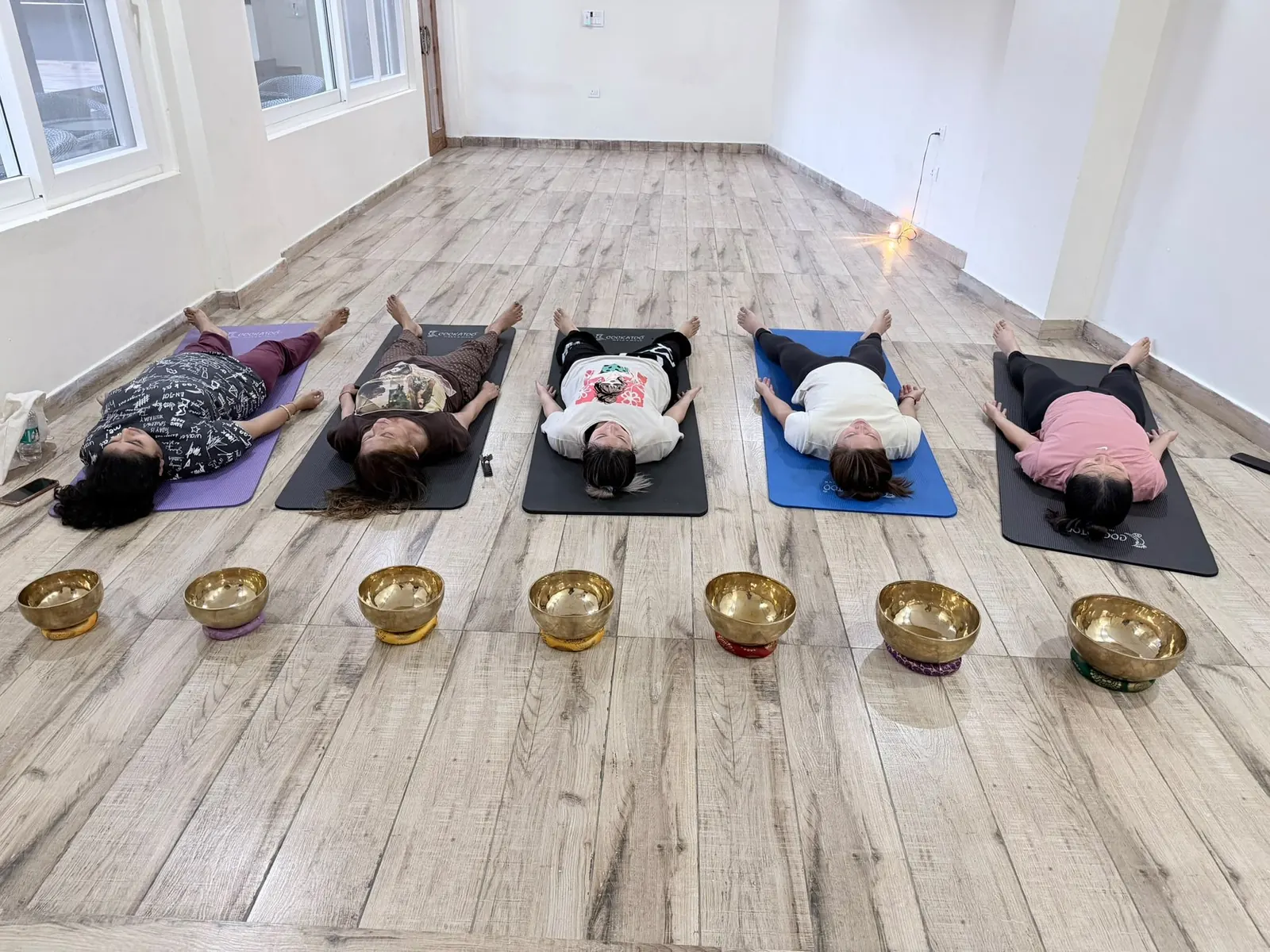 Guests resting during a singing bowl healing session