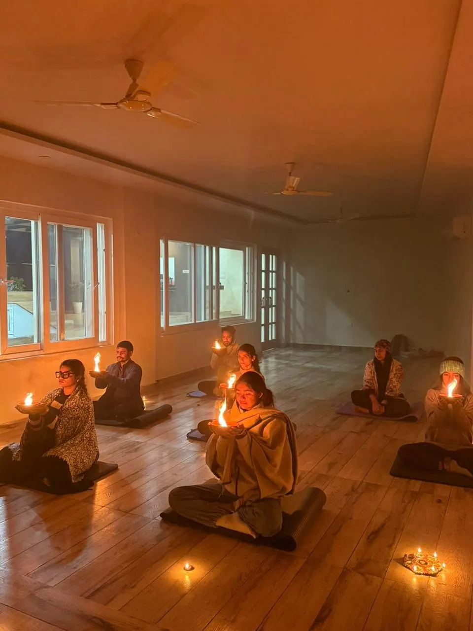 Candlelit evening practice in the yoga shala