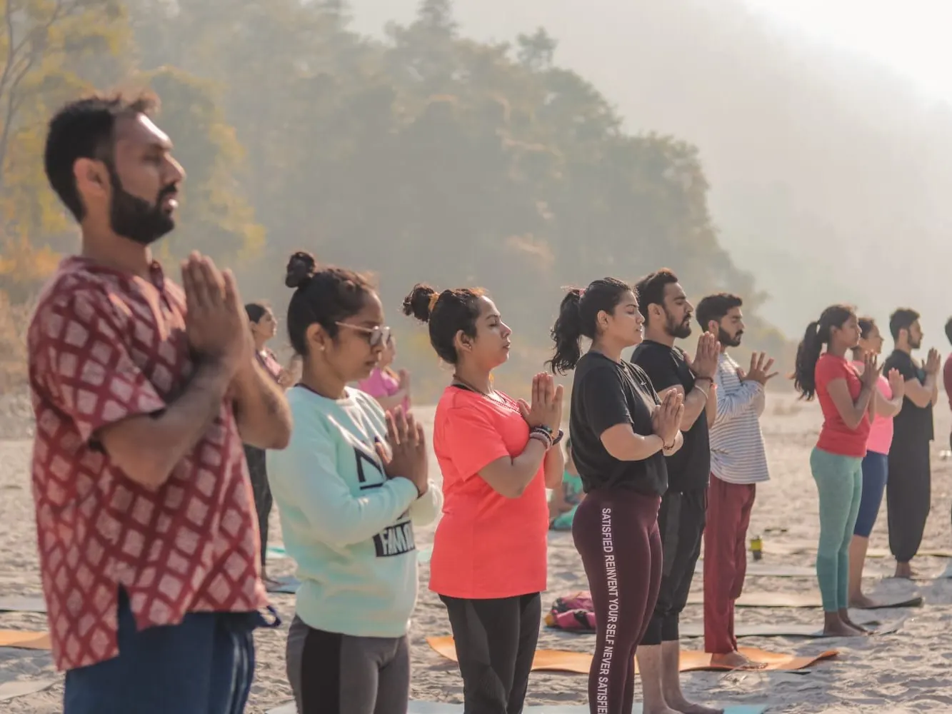 Retreat guests at a riverside morning session
